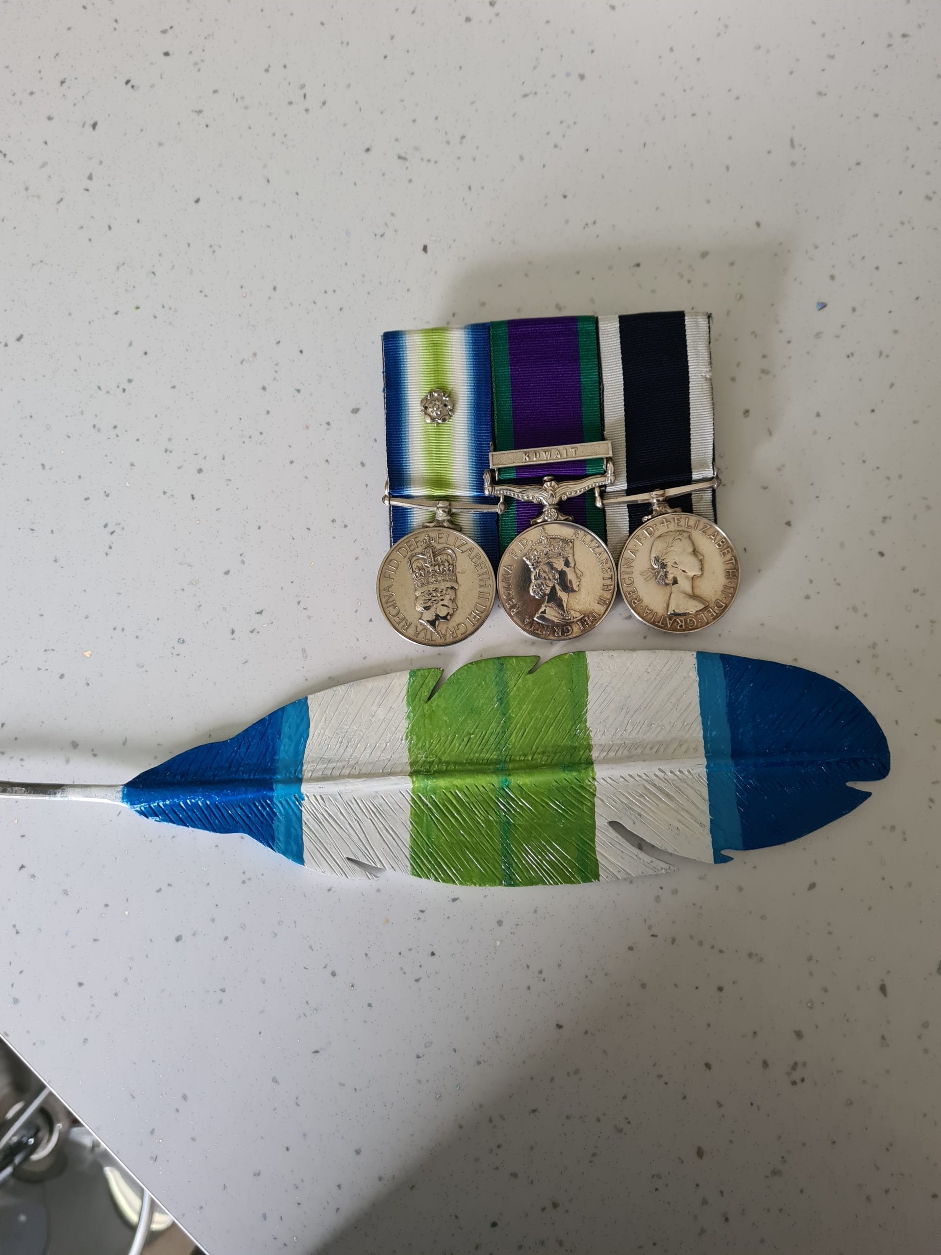 South Atlantic Medal Feather Three military medals with colorful feather